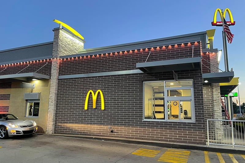 Commercial building at night with clean permanent LED lighting along the parapet