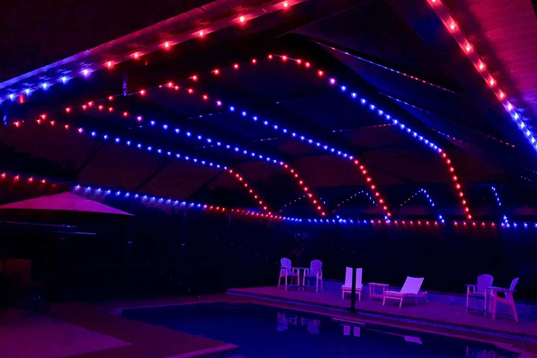 Pool enclosure lit with color-changing LEDs